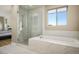 Beautiful bathroom features a glass shower and a separate soaking tub, offering a spa-like experience at 6433 Farness St, Las Vegas, NV 89135