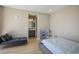 Neutral bedroom features a gray daybed, white bedding, and an adjoining bathroom at 6433 Farness St, Las Vegas, NV 89135