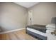 Neutral bedroom featuring wood-look flooring and minimalist decor, creating a calm, inviting space at 6433 Farness St, Las Vegas, NV 89135