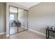 Bedroom featuring a mirrored closet, a desk, and wood-look floors at 6433 Farness St, Las Vegas, NV 89135