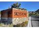 Skystone community entrance sign with stone base and flowering bushes at 6433 Farness St, Las Vegas, NV 89135