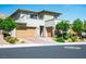 Contemporary two-story home with a three-car garage and landscaped front yard at 6433 Farness St, Las Vegas, NV 89135