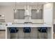 Modern kitchen featuring a quartz countertop island with pendant lighting and gray cabinetry at 6433 Farness St, Las Vegas, NV 89135