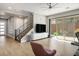 Open-concept living area featuring a staircase, media center, and sliding glass doors to the outdoor patio at 6433 Farness St, Las Vegas, NV 89135
