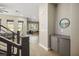 Bright living space featuring wood-look flooring, gray cabinets, and a view of the dining area for open living at 6433 Farness St, Las Vegas, NV 89135