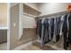 Organized walk-in closet with ample hanging space, shelving, and wood-look flooring for efficient storage at 6433 Farness St, Las Vegas, NV 89135