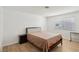 Bedroom with wood-look floors, neutral walls and a window with blinds at 6711 W Charleston Blvd # 4, Las Vegas, NV 89146