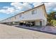 Row of multi-Gathering homes with white stucco and red tile roofs, each unit offering covered private parking below at 6711 W Charleston Blvd # 4, Las Vegas, NV 89146