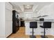 Eat-in kitchen features a bar, granite counters and black appliances at 6711 W Charleston Blvd # 4, Las Vegas, NV 89146