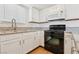 Galley kitchen features white cabinetry, granite counters and modern appliances at 6711 W Charleston Blvd # 4, Las Vegas, NV 89146