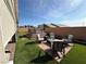 Backyard featuring a seating area with artificial grass, hardscape and a hot tub at 689 Moonstone Beach Pl, Henderson, NV 89011