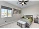Bedroom with neutral walls, carpet, blinds, dinosaur theme, storage bench, and view to the yard at 689 Moonstone Beach Pl, Henderson, NV 89011