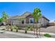 Beautiful view of the home's exterior showcasing desert landscaping and modern architectural design at 689 Moonstone Beach Pl, Henderson, NV 89011