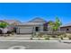 Charming single-story home showcasing desert landscaping, stone accents, and a brick driveway at 689 Moonstone Beach Pl, Henderson, NV 89011