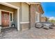 Inviting front porch featuring a seating area with a stone facade at 689 Moonstone Beach Pl, Henderson, NV 89011