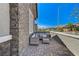 Cozy front porch featuring a seating area and textured stone accents at 689 Moonstone Beach Pl, Henderson, NV 89011
