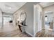 Elegant hallway with stylish decor, wood-look tile flooring, and access to the living spaces at 689 Moonstone Beach Pl, Henderson, NV 89011