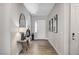 Well-lit hallway with neutral decor, wood-look tile, and elegant accents at 689 Moonstone Beach Pl, Henderson, NV 89011