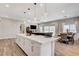 Open concept kitchen with large island and adjoined living and dining rooms at 689 Moonstone Beach Pl, Henderson, NV 89011
