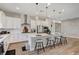 Stylish kitchen with a large island, pendant lighting, bar stool seating, and wood-look floors at 689 Moonstone Beach Pl, Henderson, NV 89011