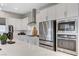 Modern kitchen featuring white cabinets, stainless steel appliances, and a sleek, bright countertop at 689 Moonstone Beach Pl, Henderson, NV 89011