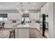 Modern kitchen featuring white cabinetry, stainless steel appliances, and a central island at 689 Moonstone Beach Pl, Henderson, NV 89011