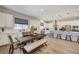 Open concept kitchen with dining table and white cabinets at 689 Moonstone Beach Pl, Henderson, NV 89011