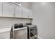 Convenient laundry room with modern washer and dryer units and ample storage space at 689 Moonstone Beach Pl, Henderson, NV 89011