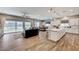Open concept living room and kitchen featuring modern decor and a seamless transition to the outdoor patio at 689 Moonstone Beach Pl, Henderson, NV 89011