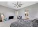 Serene main bedroom with a ceiling fan, walk-in closet, and en-suite bathroom access at 689 Moonstone Beach Pl, Henderson, NV 89011