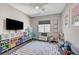Spacious playroom with colorful decor, window for natural light, and ample space for activities at 689 Moonstone Beach Pl, Henderson, NV 89011