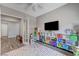Inviting playroom with a colorful rug, storage for toys, and a comfortable seating area at 689 Moonstone Beach Pl, Henderson, NV 89011