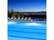 Inviting community pool with lounge chairs and a stunning city skyline in the background at night at 689 Moonstone Beach Pl, Henderson, NV 89011