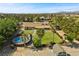 Expansive aerial view of a property with a pool, large yard, and versatile outbuilding at 7350 W Rome Blvd, Las Vegas, NV 89131