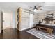 Bedroom featuring a wood accent wall, sliding barn door, and modern ceiling fan at 7350 W Rome Blvd, Las Vegas, NV 89131