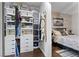 Spacious walk-in closet featuring custom shelving and storage solutions next to the bed at 7350 W Rome Blvd, Las Vegas, NV 89131