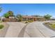 Wide driveway leads to a single-story home featuring desert landscaping and an RV cover at 7350 W Rome Blvd, Las Vegas, NV 89131