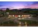 Charming single-story home featuring a well-manicured lawn, mature trees, and mountain views at 7350 W Rome Blvd, Las Vegas, NV 89131