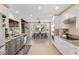 Updated kitchen with two-tone cabinets, granite countertops, and stainless steel appliances opens to the dining area at 7350 W Rome Blvd, Las Vegas, NV 89131