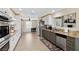 Well-lit kitchen featuring stainless steel appliances, granite countertops, and two-tone cabinetry, ready for any chef at 7350 W Rome Blvd, Las Vegas, NV 89131