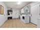 Well-lit laundry area with modern washer/dryer, storage cabinets, and access to an exterior door at 7350 W Rome Blvd, Las Vegas, NV 89131