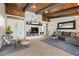 Cozy living room featuring stone fireplace, wood ceilings, neutral colors and tiled floors at 7350 W Rome Blvd, Las Vegas, NV 89131