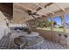 Relaxing enclosed patio featuring cozy seating, decorative lighting, and a pleasant view of the landscaped yard at 7350 W Rome Blvd, Las Vegas, NV 89131