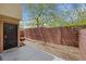 Enclosed backyard offers privacy with a tall brick wall and space for outdoor furniture and a BBQ grill at 7361 Ringquist St, Las Vegas, NV 89148