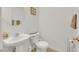 Bathroom with a pedestal sink, commode, and decorative mirror at 7361 Ringquist St, Las Vegas, NV 89148