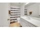 Bathroom featuring modern fixtures, vanity, and a shower with a striped curtain at 7361 Ringquist St, Las Vegas, NV 89148