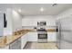 Modern kitchen featuring stainless steel appliances, granite countertops, and ample cabinet space at 7361 Ringquist St, Las Vegas, NV 89148