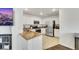 Bright kitchen features stainless steel appliances, stone countertops, and tile flooring at 7361 Ringquist St, Las Vegas, NV 89148