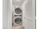 Efficient laundry room features a stacked washer and dryer unit, maximizing space and convenience at 7361 Ringquist St, Las Vegas, NV 89148
