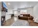 Cozy living room with modern flooring, a comfortable sofa, and large windows at 7361 Ringquist St, Las Vegas, NV 89148